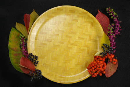Autumn restaurant menu free text copy space with forest berries and cutlery on black backgroundの写真素材