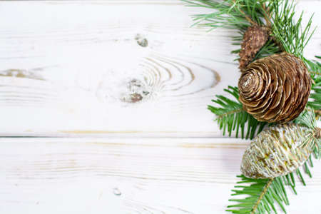 Christmas fir tree with cones copy space on white wooden backgroundの写真素材