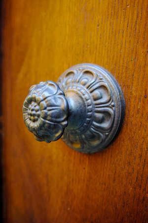 Old ancient door knocker on wooden door, Tuscany, Italyの写真素材