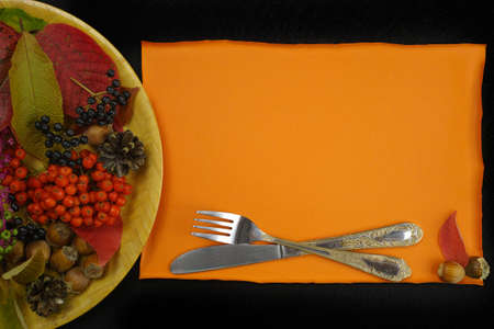 Autumn restaurant menu free text copy space with forest berries and cutlery on black backgroundの写真素材