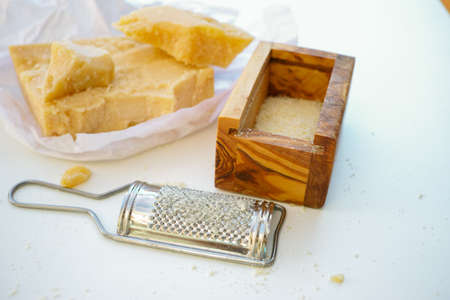 Parmesan cheese. Grated Parmesan cheese and Olive Wood Parmesan Cheese Grater.の写真素材