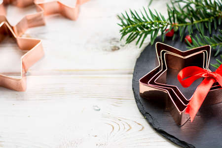 Star-form copper baking pasry form for Christmas cookies with Christmas decorationの写真素材