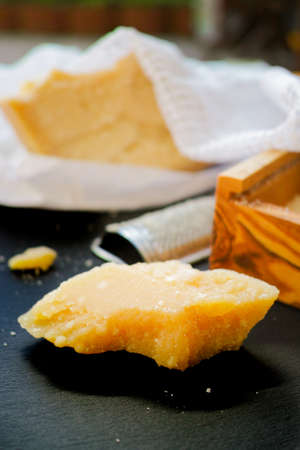 Parmesan cheese. Grated Parmesan cheese and Olive Wood Parmesan Cheese Grater.の写真素材