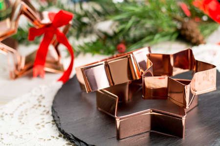 Star-form copper baking pasry form for Christmas cookies with Christmas decorationの写真素材