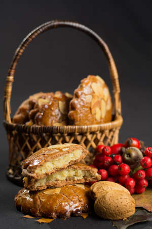 Typical Dutch filled spicy  cookies with almonds on autumn colored and dark background