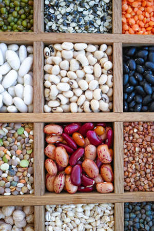 Collection assorted of lentils, beans, peas, grain, groats, soybeans, legumes in wooden boxの写真素材