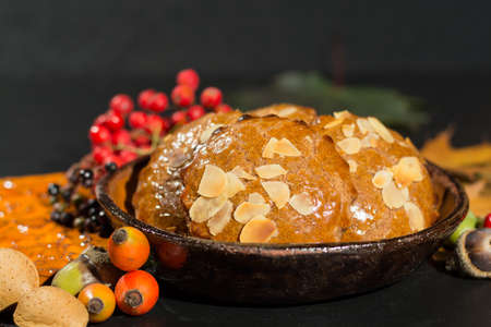 Typical Dutch filled spicy  cookies with almonds on autumn colored and dark background