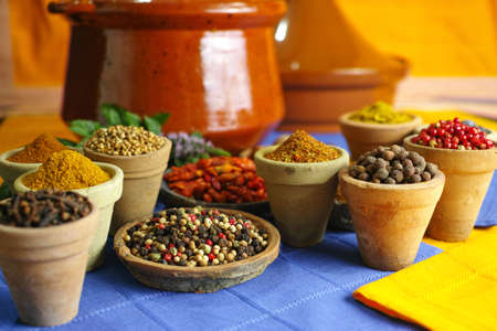 Collection of different spices in old clay bowls in colorful oriental styleの写真素材