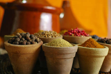 Collection of different spices in old clay bowls in colorful oriental styleの写真素材