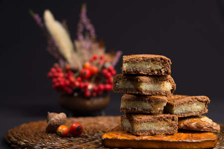 Fresh Dutch filled spicy  cookies with almonds on autumn colored and dark backgroundの写真素材