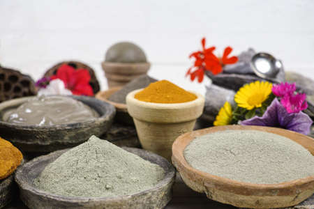 Ancient minerals - black, green, blue, ochre clay powder and mud mask for spa, beauty conceptの写真素材