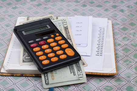 Utility or mortgage bills, calculator and US dollars - finance concept, payments and problemsの写真素材