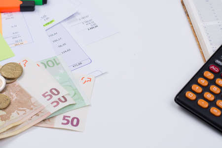 Utility or mortgage bills, calculator and Euro banknote and coins - finance concept, payments and problemsの写真素材