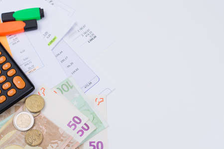 Utility or mortgage bills, calculator and Euro banknote and coins - finance concept, payments and problemsの写真素材