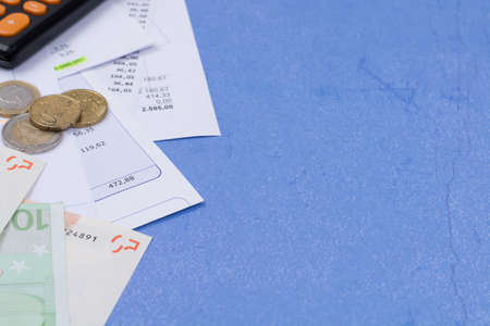 Utility or mortgage bills, calculator and Euro banknote and coins - finance concept, payments and problemsの写真素材
