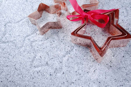 Copper star-shaped cookies cutter on shiny mirrored backgroundの写真素材