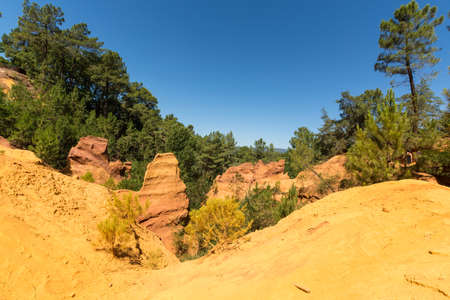 Oragne ochre picturesque hills. Languedoc - Roussillon, Provence, France. Preserve natural dye production - ocher.の写真素材