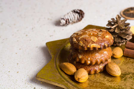Christmas cookies with almond nuts and ginger on golden plate, holiday conceptの写真素材