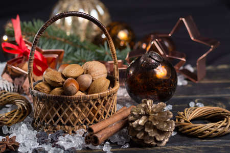 Winter cristmas nuts in wicked basket with christmas decorationの写真素材