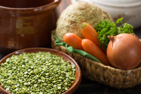 Ingredients for dried split pea vegetarian soup - carrot, celery root, onion, parsleyの写真素材
