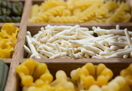 Variety of types, colors and shapes of Italian pasta. Dry pasta background, close upの写真素材