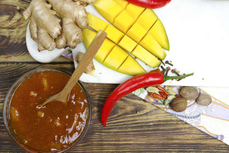Bowl of homemade frsh Mango Chutney on old wooden tableの写真素材