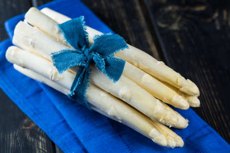 Spring season - fresh white asparagus on black wooden backgroundの写真素材
