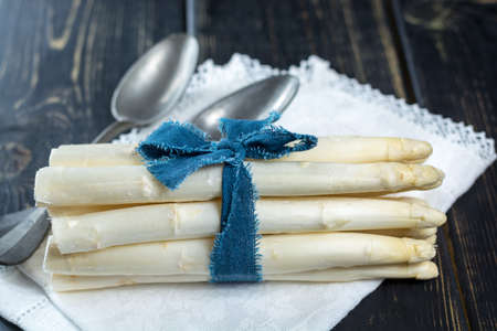 Spring season - fresh white asparagus on black wooden backgroundの写真素材
