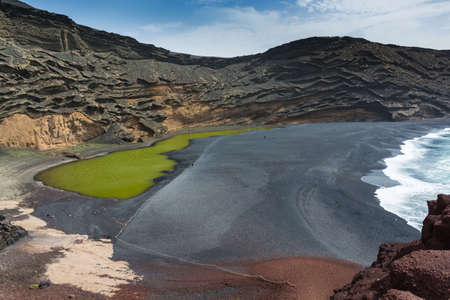 View into a volcanic crater with its green lake near El Golfo, Lanzarote island, Spain - travel destinarionの写真素材