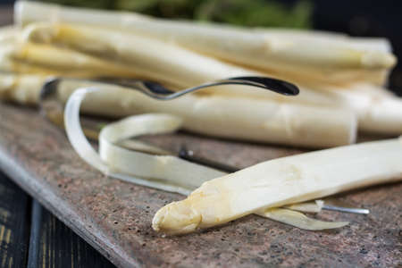 Spring season - fresh white and green asparagus on granit plank backgroundの写真素材