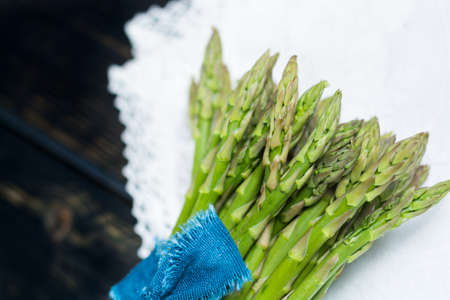 Spring season - fresh green asparagus on black wooden backgroundの写真素材