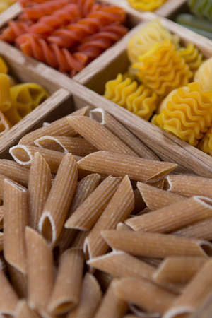 Variety of types, colors and shapes of Italian pasta. Dry pasta background, close up