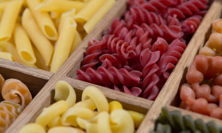 Variety of types, colors and shapes of Italian pasta. Dry pasta background, close upの写真素材