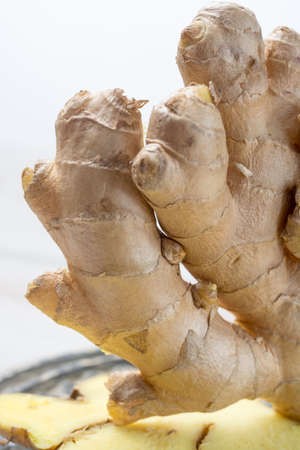 Fresh sliced raw ginger - ingredient for healthy foodの写真素材