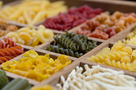 Variety of types, colors and shapes of Italian pasta. Dry pasta background, close upの写真素材
