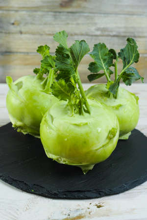 Fresh kohlrabi with green leaves reay to eatの写真素材