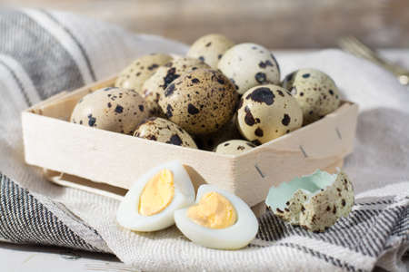 Small quail eggs in wooden box, Easter concept, diet mealの写真素材