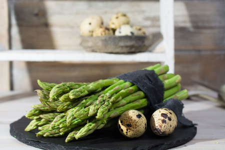 Spring season, diet meal - fresh green asparagus and quail eggsの写真素材