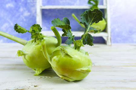 Fresh kohlrabi with green leaves reay to eatの写真素材