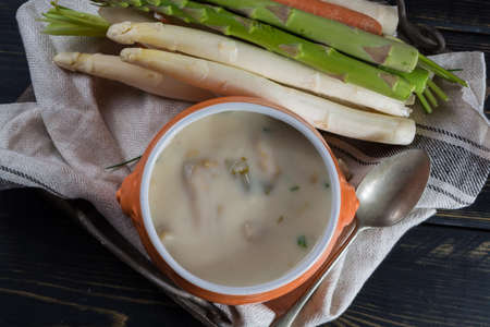 Spring season - white and green fresh asparagus cream- soup, ready to eat with vegetablesの写真素材