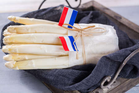 Fresh spring Dutch AA white asparagus, ready to cook, on wooden backgroung, close upの写真素材