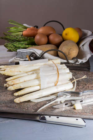 Ingredienrs for seasonal spring tasty vegetarian dinner - fresh white and green asparagus, carrot, potato and chicken eggs, ready to cook.の写真素材