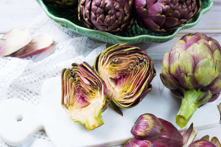 Fresh big Romanesco artichokes green-purple flower heads ready to cook seasonal foodの写真素材