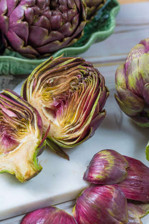 Fresh big Romanesco artichokes green-purple flower heads ready to cook seasonal foodの写真素材
