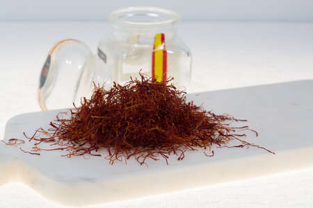 Raw Organic Red Saffron Spice on marble plankの写真素材