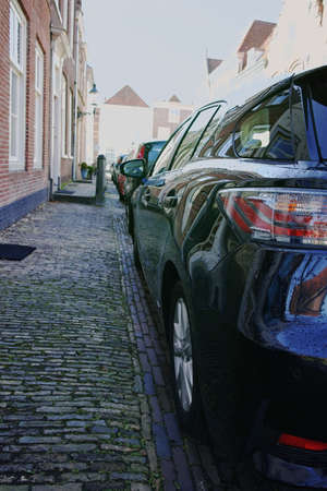 Side parking on the small street in old cityの写真素材