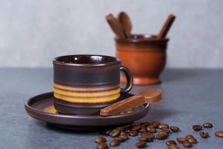 Black arabica coffee cup and roasted coffee beans on grey backgroundの写真素材