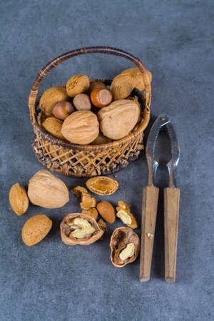 Nuts mix in shell - walnuts, hazel and almonds in wicked basketの写真素材