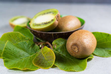 Tropical ripe organic sweet green kiwi fruit with leaves ready to eatの写真素材