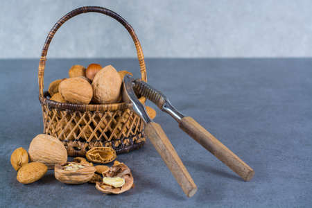 Nuts mix in shell - walnuts, hazel and almonds in wicked basketの写真素材